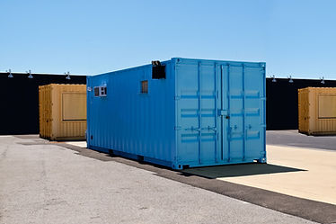 Blue and yellow mobile shipping containers in industrial site
